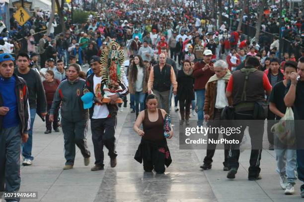 Mexican pilgrim walks on his knees during the annual celebrations held at the Basilica of Guadalupe in Mexico City on December 11, 2018. Mexicans...