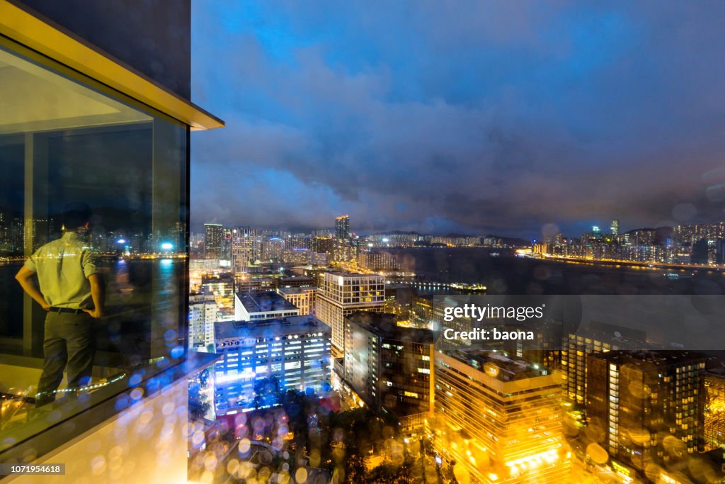 Businessman looking at city night scene