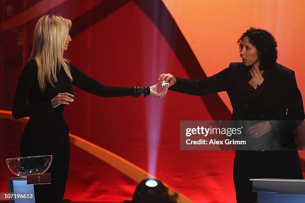 Adriana Karembeu hands a ball to Steffi Jones, head of the Local Organising Committee during the offical FIFA 2011 Women 's World Cup final draw on...