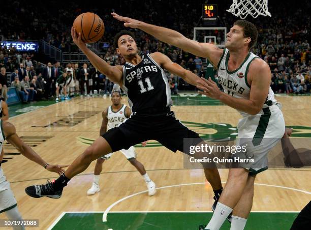 Bryn Forbes of the San Antonio Spurs shoots against Brook Lopez of the Milwaukee Bucks at Fiserv Forum on November 24, 2018 in Milwaukee, Wisconsin....