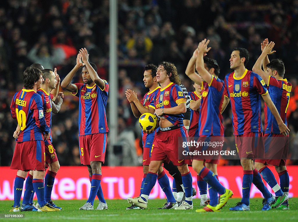 Barcelona's captain Carles Puyol (C) cel