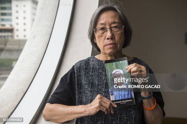 Shui-Meng Ng holds a picture of her missing Laos husband Sombath Somphone, an award-winning environmental campaigner following a press conference in...