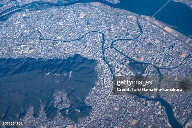 tokushima city in tokushima prefecture in japan daytime aerial view from airplane - tokushima prefecture stock pictures, royalty-free photos & images