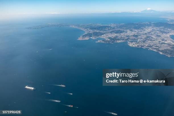 tankers sailing on tokyo bay, mt. fuji and miura peninsula in kanagawa prefecture in japan daytime aerial view from airplane - tokyo bay stock pictures, royalty-free photos & images