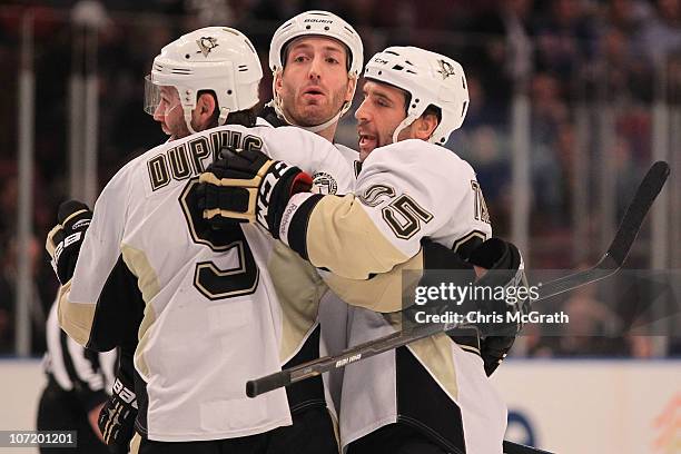 Maxime Talbot of the Pittsburgh Penguins celebrates his goal with team mates Deryk Engelland and Brooks Orpik against the New York Rangers during...