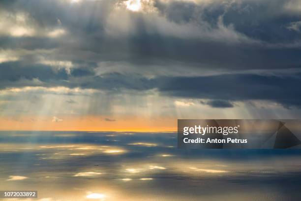 sunset over the sea. sunrays illuminating the sea, aerial view - early access stock pictures, royalty-free photos & images
