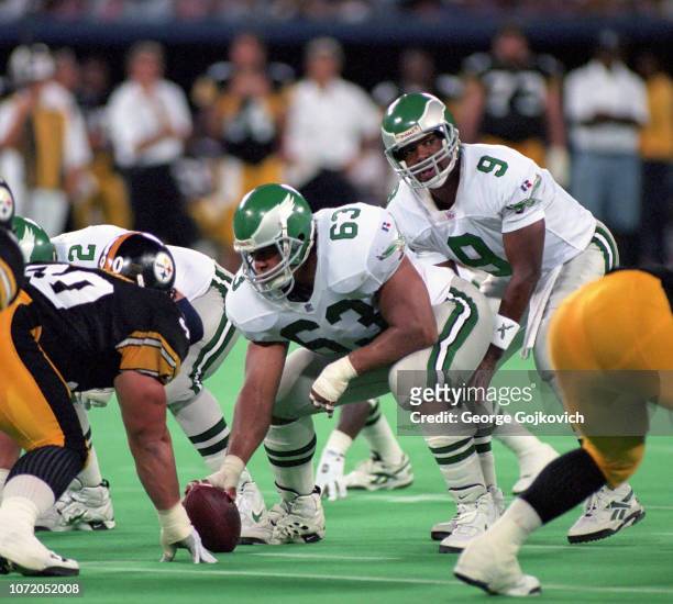 Quarterback Rodney Peete of the Philadelphia Eagles stands behind center Raleigh McKenzie during a preseason game against the Pittsburgh Steelers at...