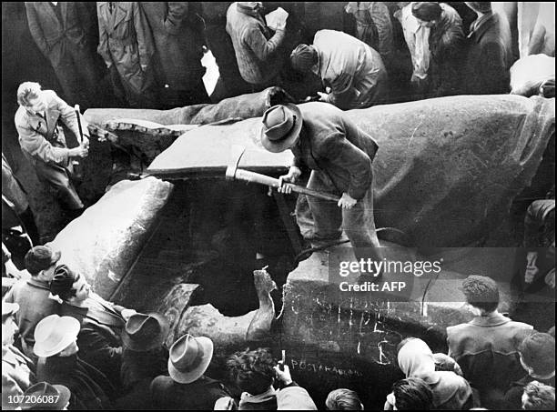 Residents of Budapest destroy 02 November 1956 a huge statue of Stalin downtown the Hungarian capital during a demonstration against the communist...