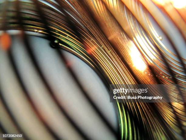 copper-colored helical coil spring close-up - copper detail stock pictures, royalty-free photos & images