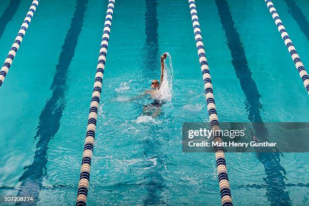 male swimmer swimming the backstroke - backstroke stock pictures, royalty-free photos & images