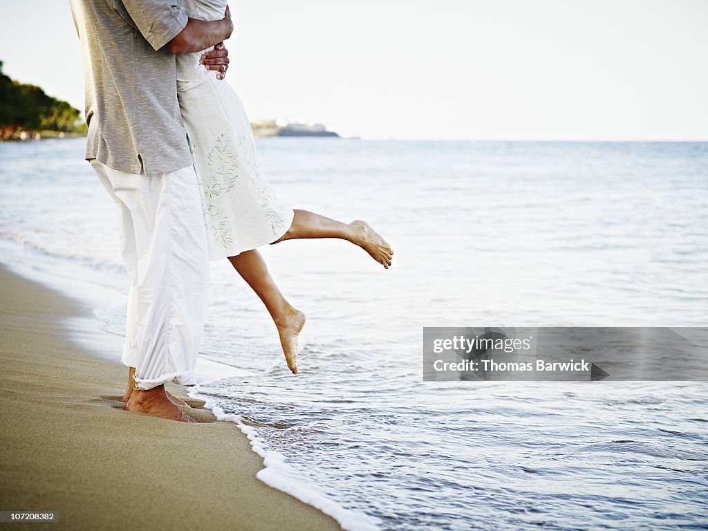 Man and woman embracing on tropical beach