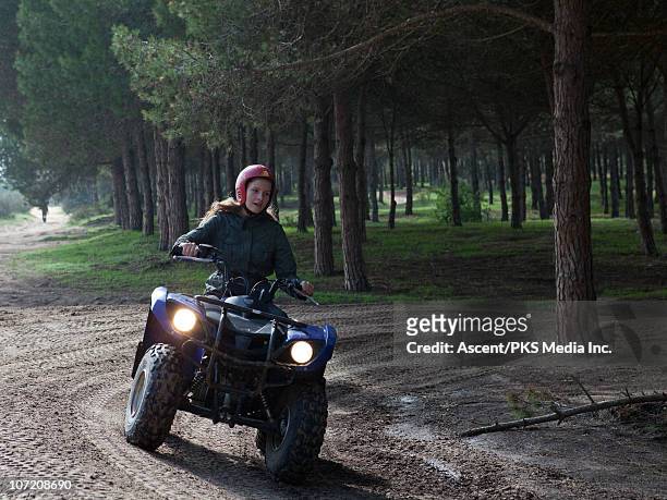 teenage girl drives quad (atv) on forest course - tunisian girls stock-fotos und bilder