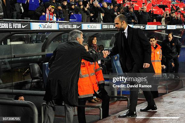Head coach Jose Mourinho of Real Madrid and head coach Josep Guardiola of Barcelona shake hands prior to the La Liga match between Barcelona and Real...
