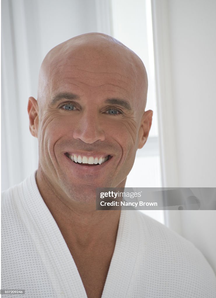 Bald caucasian man smiling at camera.