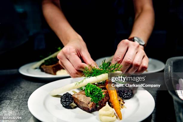 plates at the pass ready to be served. - asparagus stock pictures, royalty-free photos & images