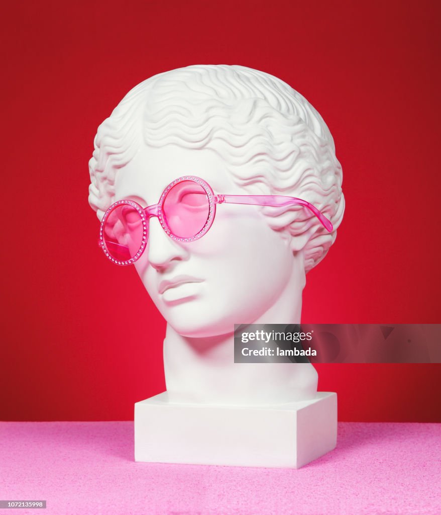 Head sculpture with pink eyeglasses