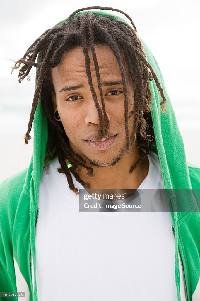 Young man with green hooded top, portrait