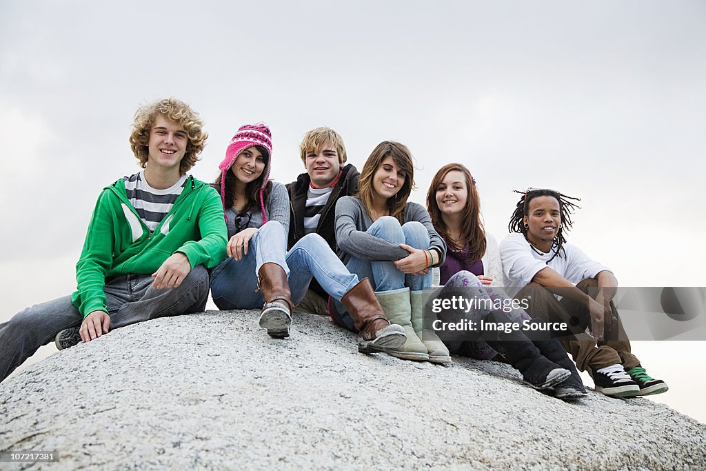 Group of friends sitting on boulder