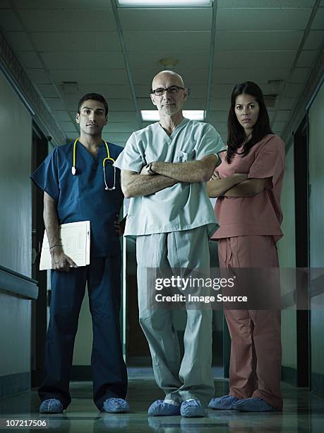 hospital staff standing in corridor - nurse standing stock pictures, royalty-free photos & images