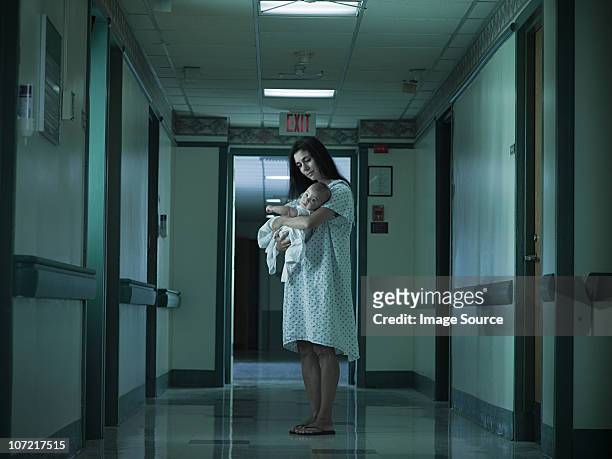 mother with nerwborn baby in hospital - dark baby stock pictures, royalty-free photos & images
