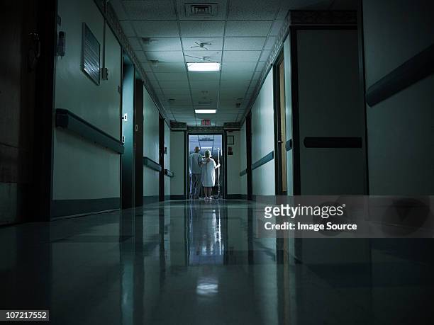 female patient with intravenous drip - dark corridor stock pictures, royalty-free photos & images