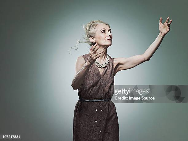 senior woman reaching out, portrait - arm reaching stock pictures, royalty-free photos & images