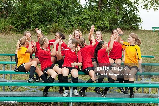 female soccer team high fiving - teen soccer player stock pictures, royalty-free photos & images