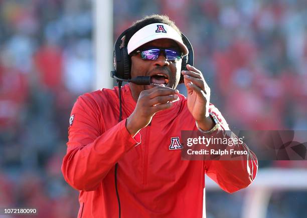 Head coach Kevin Sumlin of the Arizona Wildcats tries to call time out during second half action of a college football game against the Arizona State...