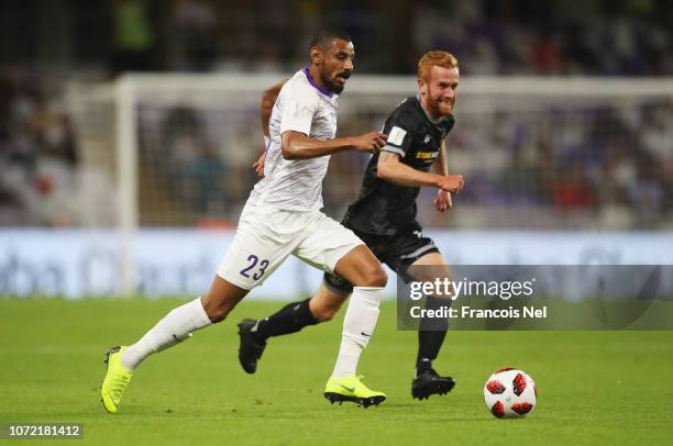 Mohamed Ahmed of Al Ain is chased by Aaron Clapham of Team Wellington during the FIFA Club World Cup first round play-off match between Al Ain FC and...