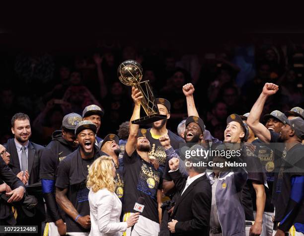 Finals: Golden State Warriors Stephen Curry victorious, holdiing up Larry O'Brien NBA Championship Trophy after winning game and series vs Cleveland...
