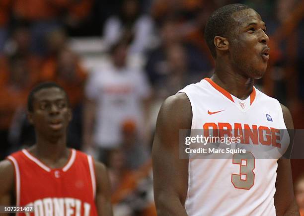 Dion Waiters of the Syracuse Orange celebrates a basket as Miles Asafo-Adiei of the Cornell Big Red looks on during the game at the Carrier Dome on...