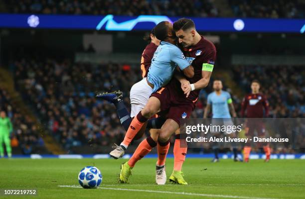 Raheem Sterling of Manchester City is tackled by Benjamin Hubner of TSG 1899 Hoffenheim during the UEFA Champions League Group F match between...