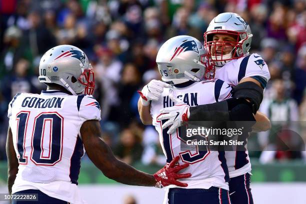 Rob Gronkowski of the New England Patriots is congratulated by his teammates Chris Hogan and Josh Gordon after his first quarter touchdown reception...