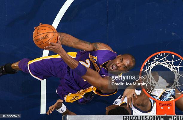 Kobe Bryant of the Los Angeles Lakers shoots a reverse layup over Hasheem Thabeet of the Memphis Grizzlies on November 30, 2010 at FedExForum in...