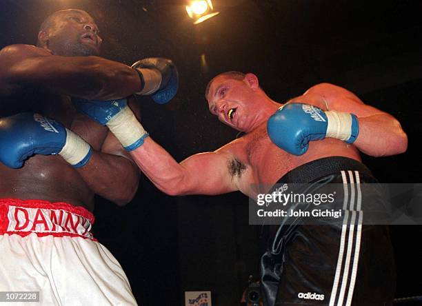 Danny Williams receives a punch from Mark Potter during his British and Commonwealth Heavyweight Title Bout held at Wembey, London. Mandatory Credit:...