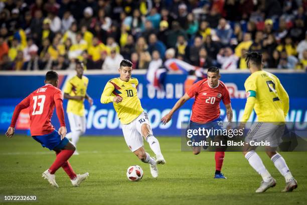 James Rodríguez of Colombia keeps the ball from David Guzman of Costa Rica during the International Friendly match between Columbia and Costa Rica at...