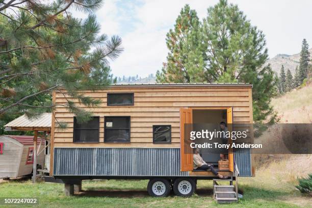 Young couple talking in doorway of their tiny house