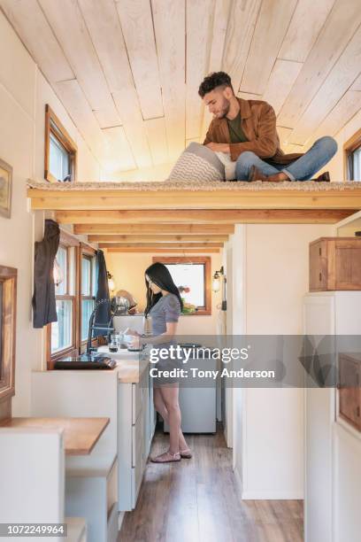 young couple at home in their tiny house - wohngebäude innenansicht stock-fotos und bilder