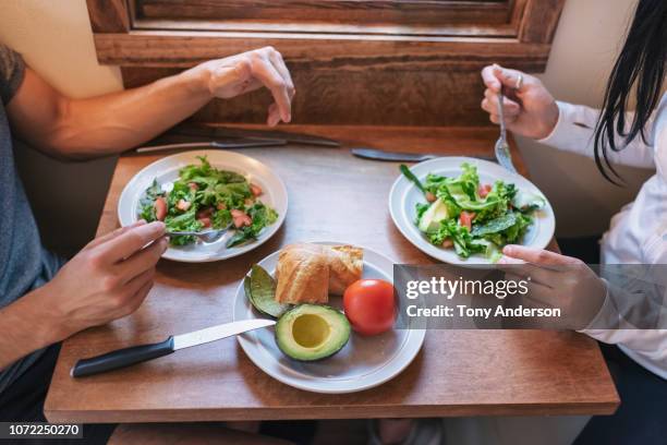 young couple having meal together detail - lowman idaho stock pictures, royalty-free photos & images
