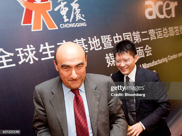 Gianfranco Lanci, chief executive officer of Acer Inc., left, and Che Min Tu, chief financial offer of Acer Inc., leave a news conference announcing...