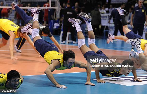 Brazilian captain Giba and Mario celebrate with teammates after defeating Russia the World League 2010 final volleyball match at Orfeo Superdomo...