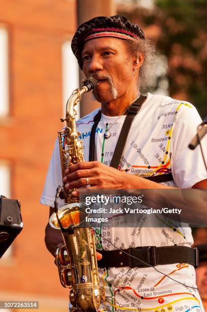 American R&B, Funk, and Jazz musician Charles Neville plays alto saxophone as he performs with the Neville Brothers at the 2004 Hudson River...