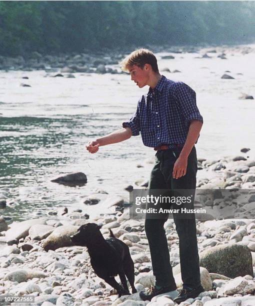 Prince William relaxes on the banks of the River Dee just a month before his mother's death, August 12, 1997 in Balmoral, Scotland.