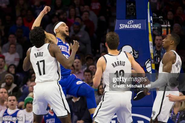 Ben Simmons of the Philadelphia 76ers reacts after dunking the ball past Ed Davis, Joe Harris, and Rondae Hollis-Jefferson of the Brooklyn Nets in...