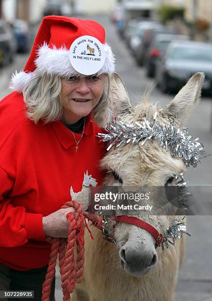 Former Home Office Minister Ann Widdecombe poses for a photograph with Dove the donkey at the launch of the Christmas campaign to save donkeys in the...