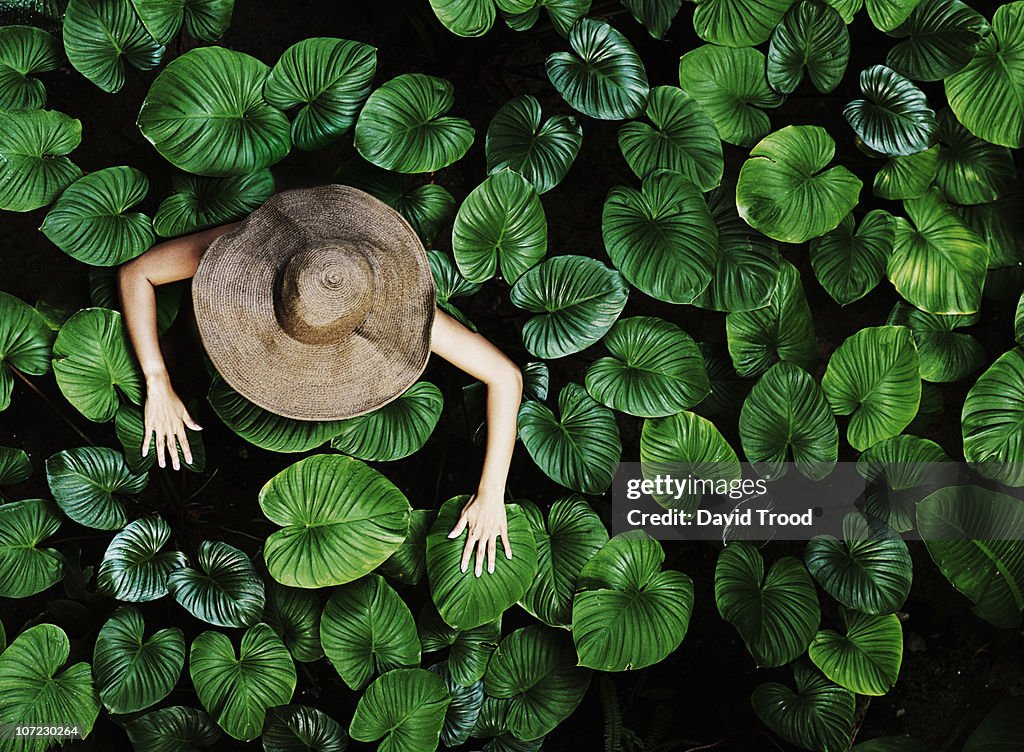 Thai woman with tropical leaves