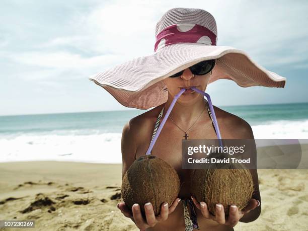 woman drinking from two coconuts - coconut water stock pictures, royalty-free photos & images