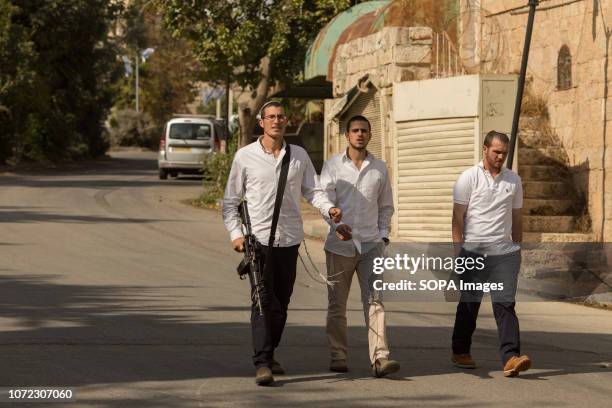 Armed settlers seen walking through the old city of Hebron. The West Bank in Palestine has been occupied by Israel since 1967. Military checkpoints,...