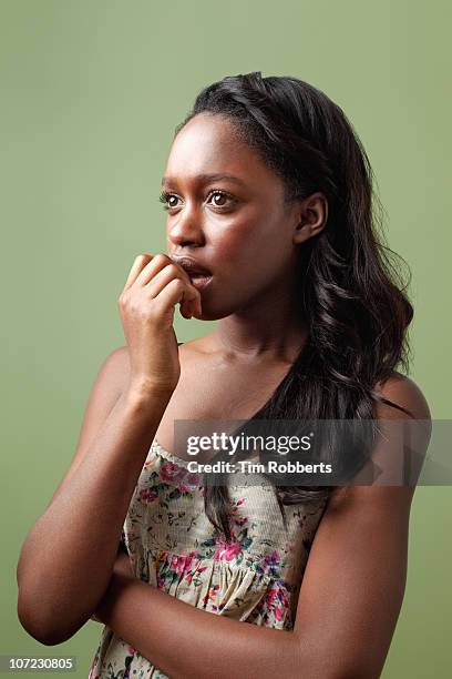 young woman with hand on her mouth. - nail biting stock pictures, royalty-free photos & images