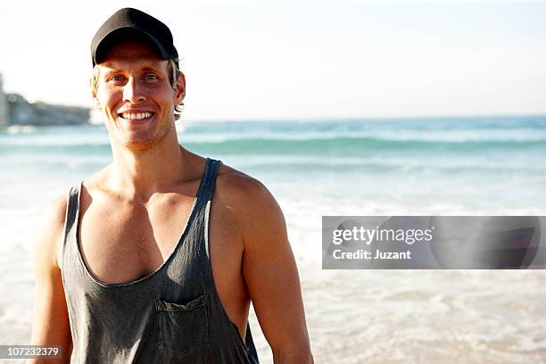 portrait of young man in gym gear outdoors - bondi stock pictures, royalty-free photos & images